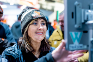 A woman looking at the Wicket Sensor.