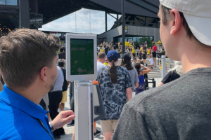 Two men looking at the Wicket Sensor.